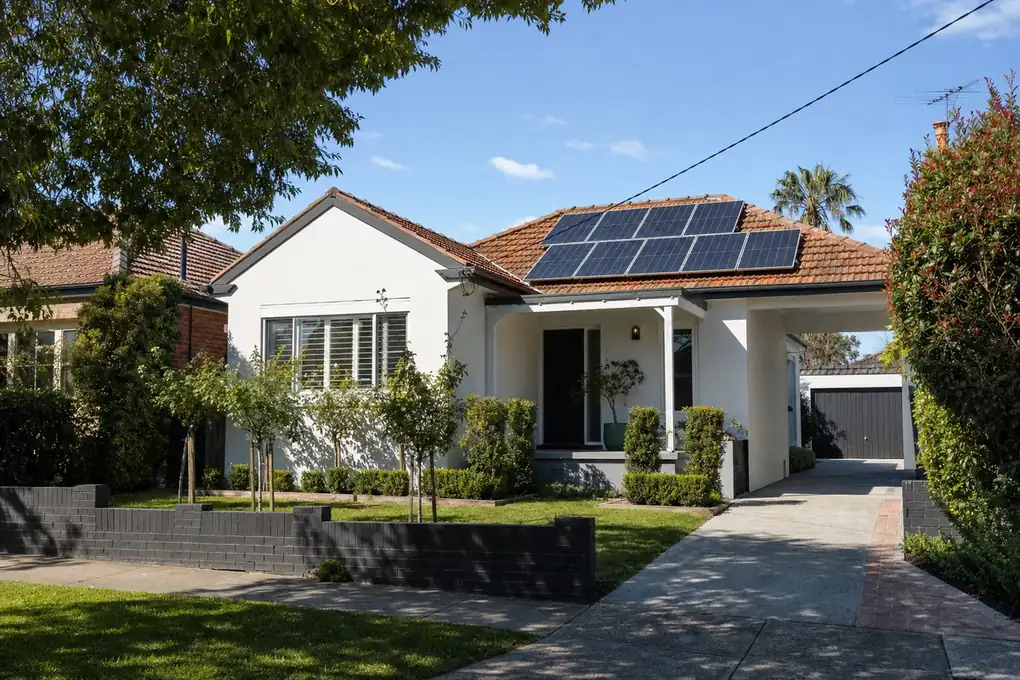 Solar battery and inverter installed in the neat garage of a Bentleigh post-war brick home, with rooftop solar panels clearly visible on the front roof slope