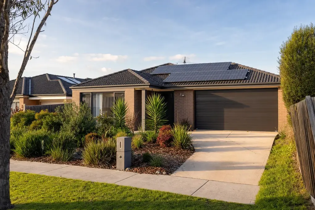 Home battery and inverter installed in the garage of a Berwick south-east Melbourne estate home, with a large-capacity rooftop solar array on the double-storey family home