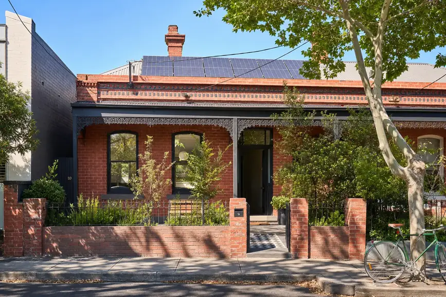 Solar battery mounted on a Brunswick post-war brick home with solar panels on the north-facing roof