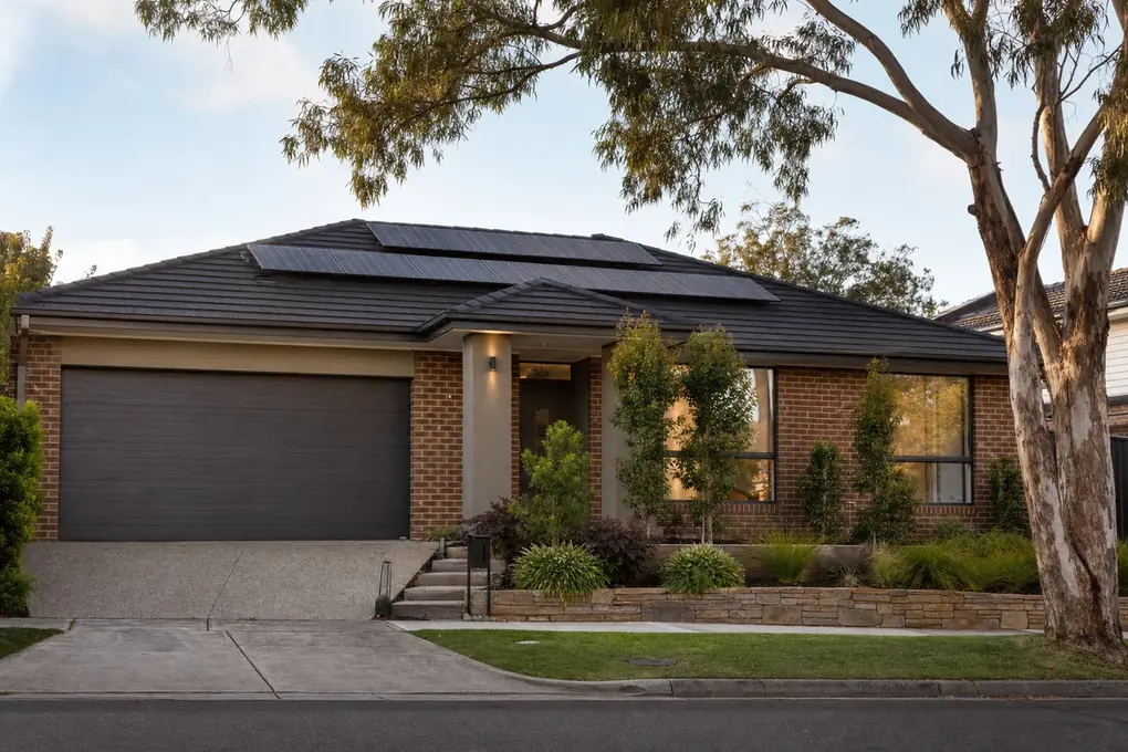 Solar battery installed in the spacious garage of a Doncaster hilltop family home, with rooftop solar panels and the Dandenong Ranges visible in the eastern background