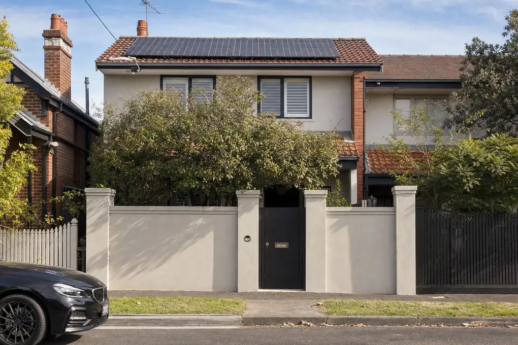 Solar battery system installed in the rear service area of a Prahran Victorian terrace, with panels on the north-facing rooftop catching afternoon sun