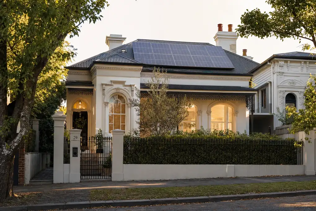 Solar battery system mounted on the wall of a South Yarra Victorian terrace home with rooftop solar panels visible